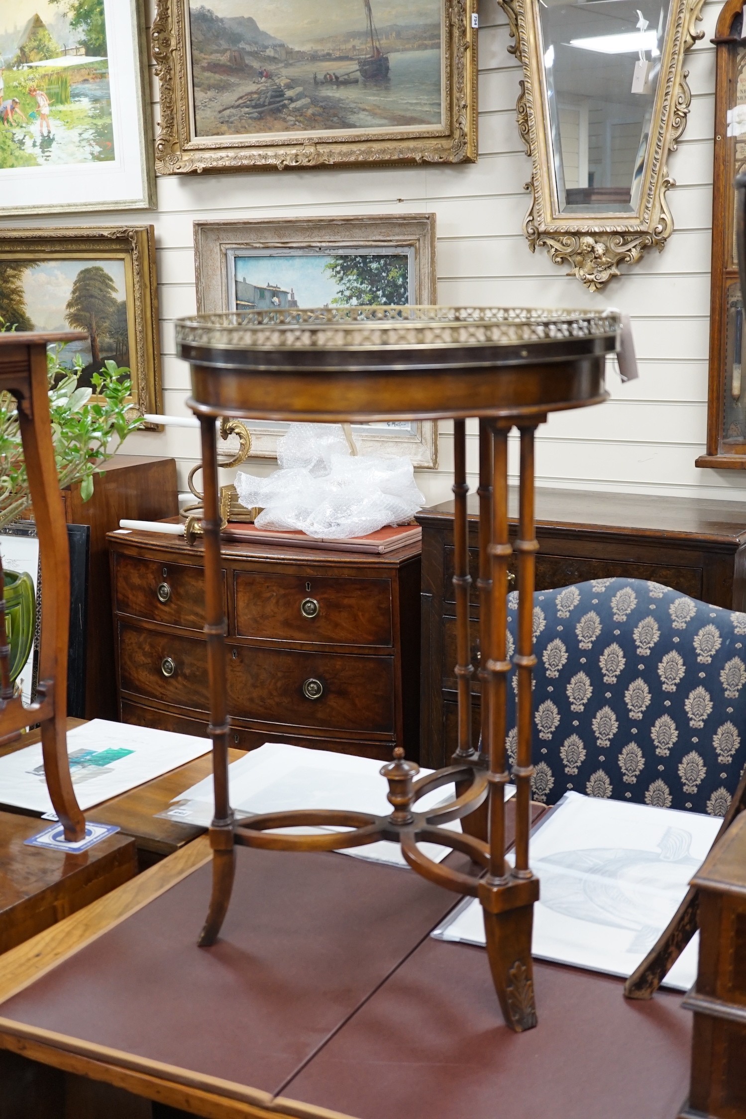 A leather topped mahogany occasional table with brass gallery, diameter 46cm *Please note the sale commences at 9am.